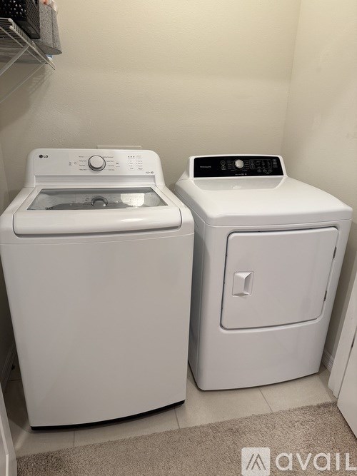 A white washing machine and dryer in a small laundry room.