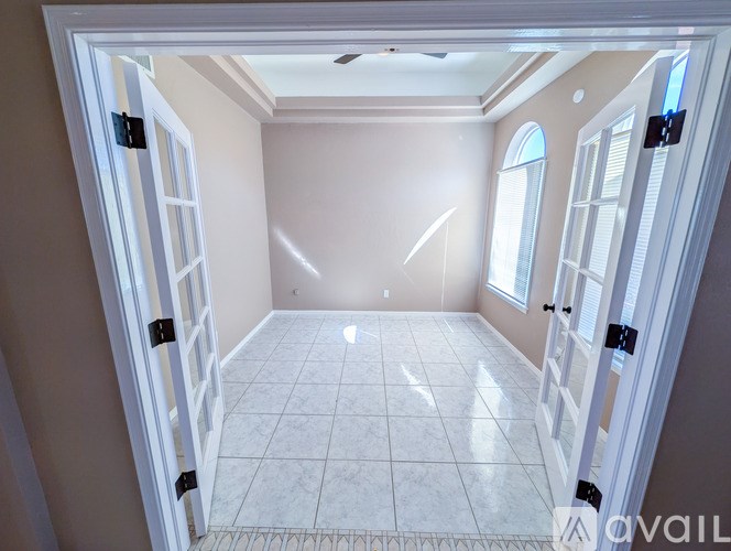 A room with a tiled floor and a ceiling fan.