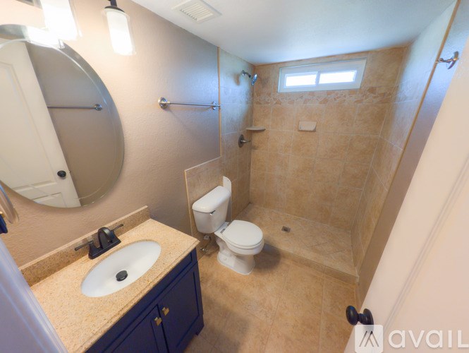 A bathroom with a sink, toilet and shower.