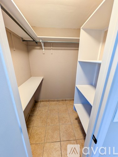 A small, empty room with a bench and shelves.