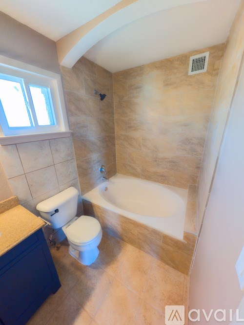 A bathroom with a toilet, sink, and bathtub.