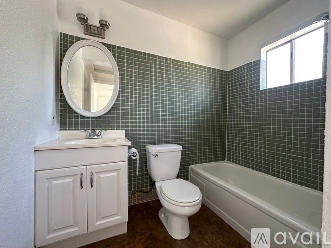 A bathroom with a white toilet and a white sink.