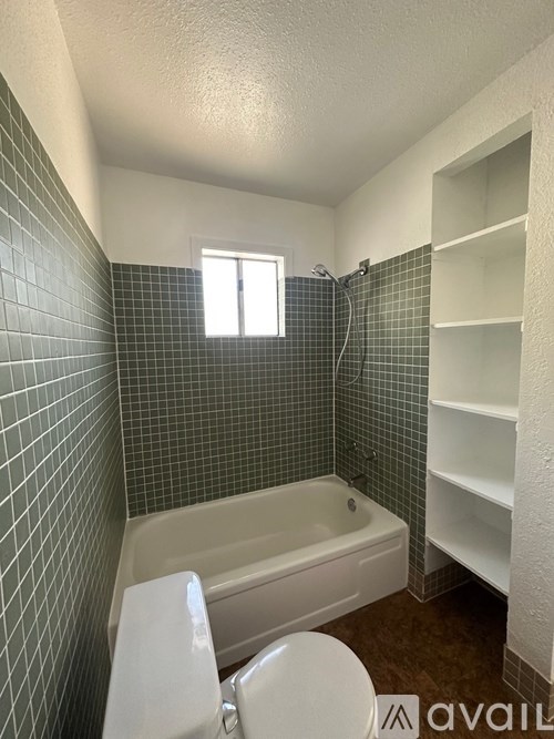 A bathroom with a white toilet and a bathtub.