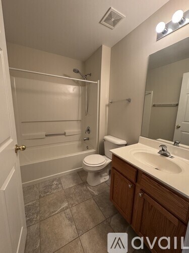 A bathroom with a toilet, sink, and bathtub.