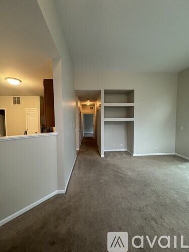 A room with a carpeted floor and a white wall with a logo that says "avaiL".