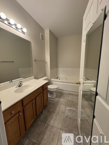 A bathroom with a sink, toilet, and bathtub.