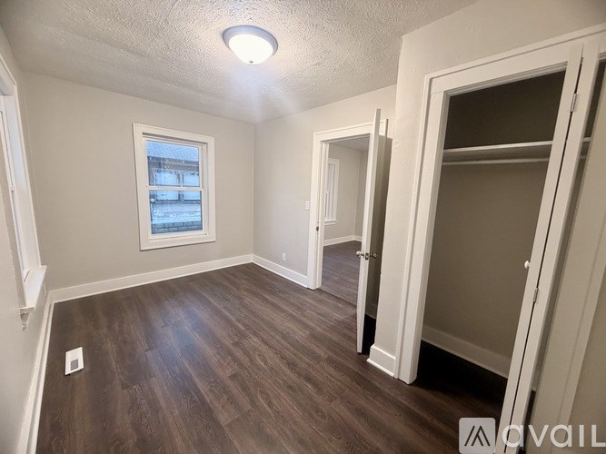 A room with wood flooring and a window.