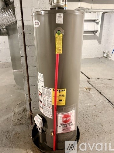 A water heater with a yellow tag on it.
