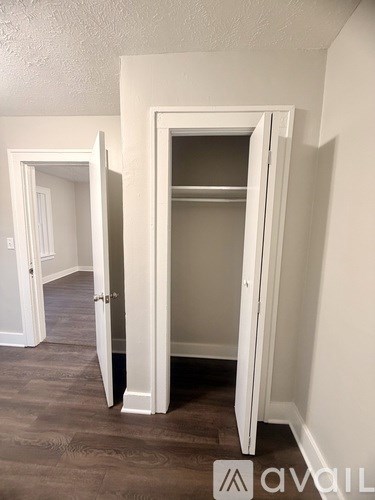 A room with a white door and a white cabinet.