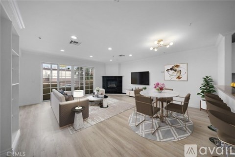 A modern living room with a fireplace and a dining table set up.