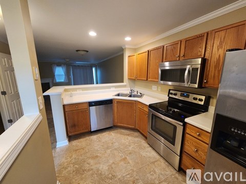 A kitchen with wooden cabinets and stainless steel appliances.