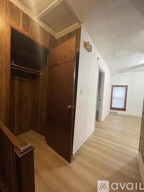 A room with a wooden door and a window.