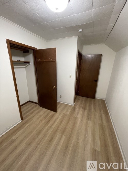 A room with two doors and a wooden floor.