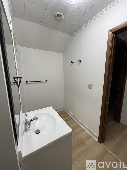 A white sink in a small bathroom.