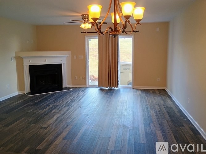 A living room with a fireplace and a chandelier.