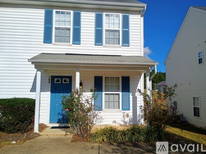 A white house with a blue door and windows.