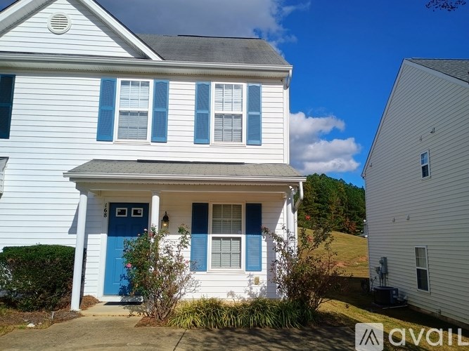 A white house with a blue door and windows.