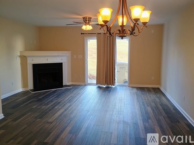 A room with a fireplace and a chandelier.