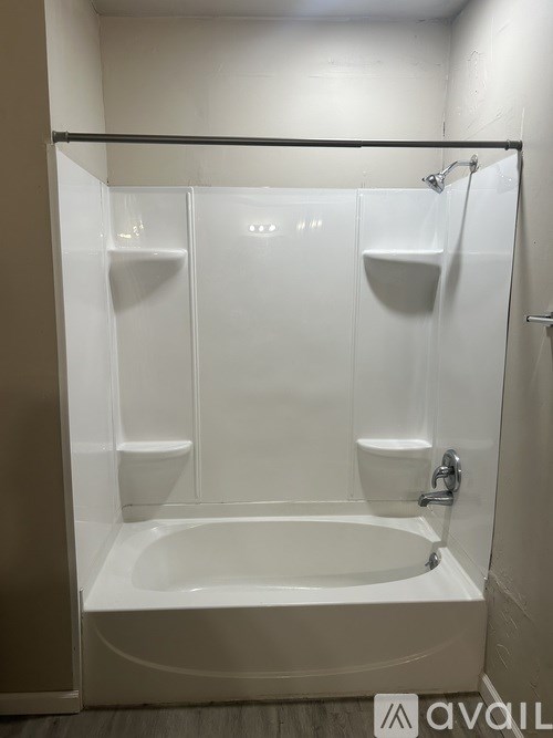 A white bathroom with a shower and a bathtub.