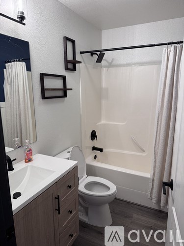 A bathroom with a toilet, sink, and bathtub.