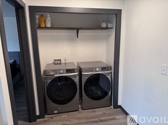 Two front loading washing machines in a laundry room.