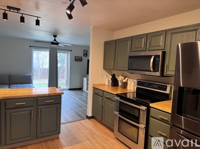 A kitchen with wooden floors and stainless steel appliances.