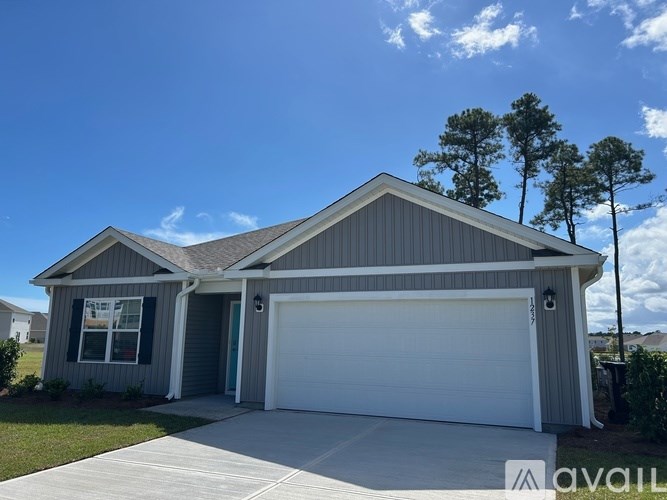 A two-car garage with a house attached is for sale.