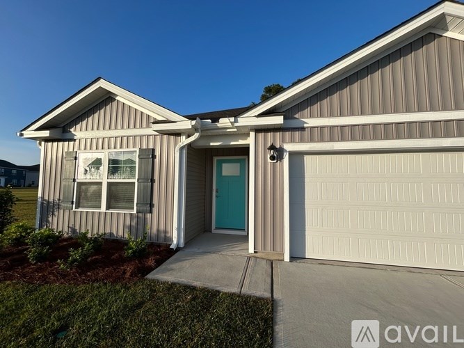 A house with a blue door and a garage door.