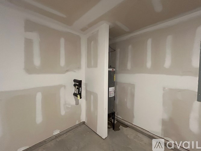 A room with white walls and a black object on the wall.