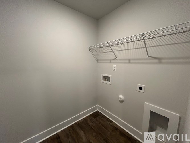 A white wall with a shelf and a fireplace.