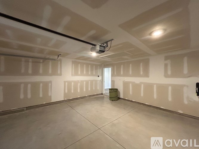 A spacious room with white walls and a concrete floor is available for rent.