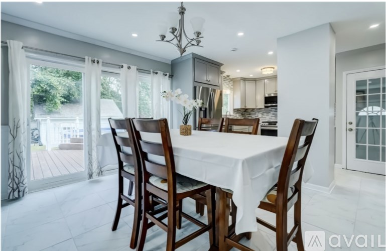 A dining room with a table set for four.