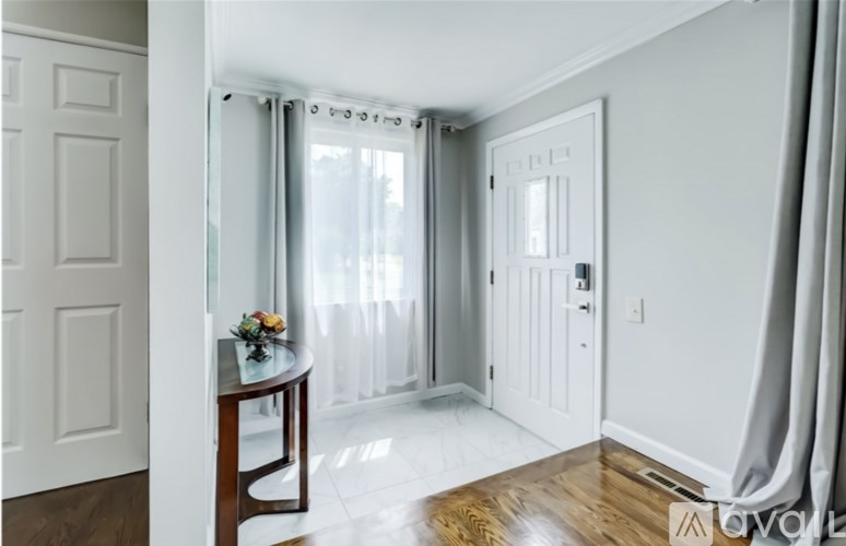 A white door with a glass window and a white wall.