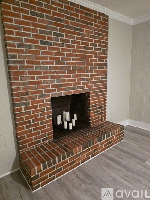A brick fireplace with a fire place in the middle.