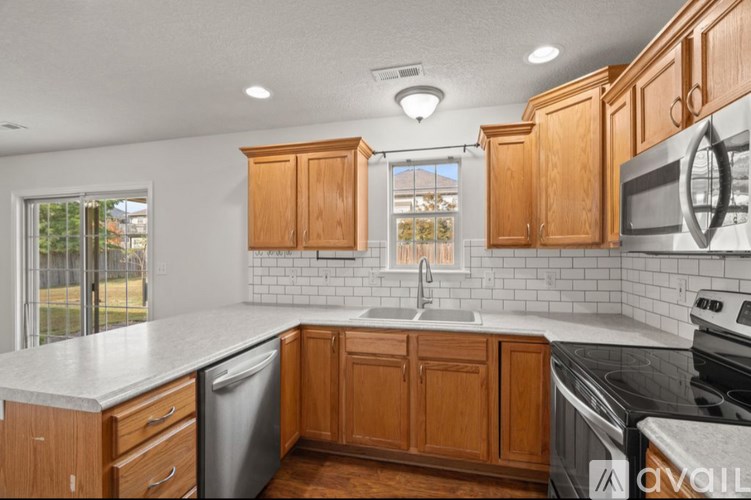 A kitchen with wooden cabinets and a white countertop.