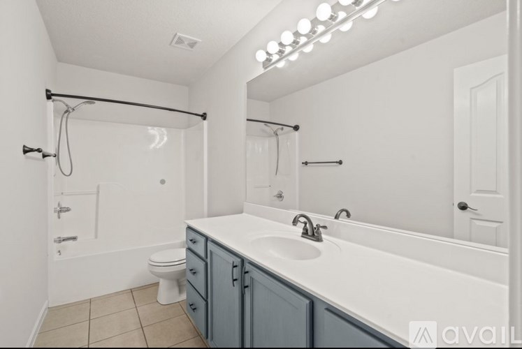 A bathroom with a white sink and a white toilet.