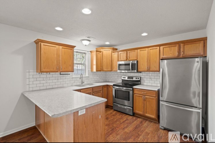 A kitchen with wooden cabinets and stainless steel appliances.