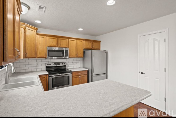 A kitchen with wooden cabinets and a white countertop.