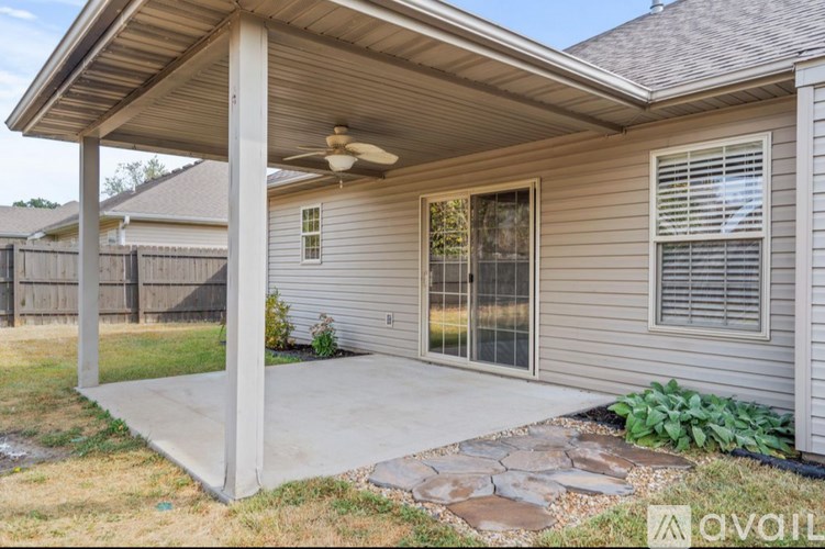 A house with a covered patio and a ceiling fan.