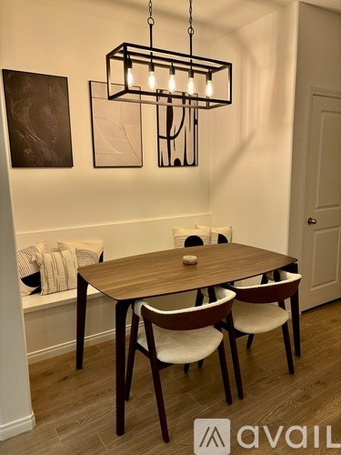 A dining room with a wooden table and chairs.