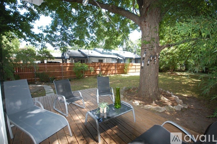 A backyard with a table and chairs.