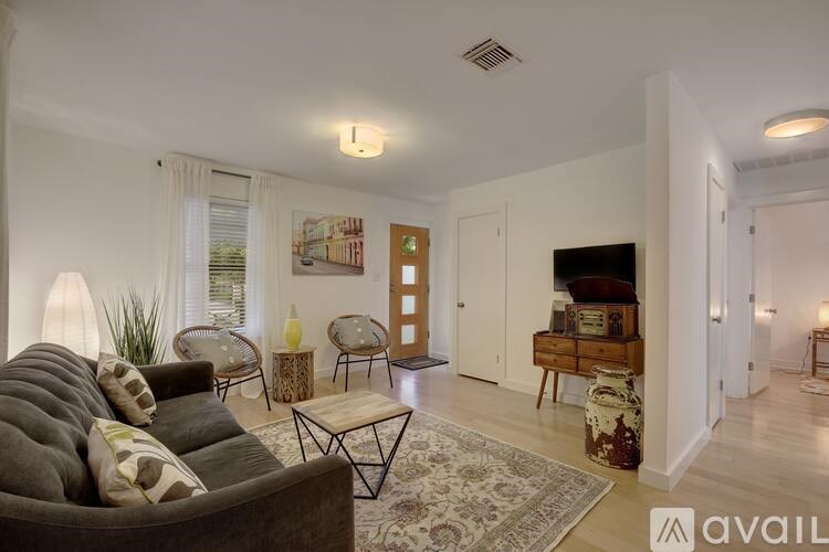 A living room with a grey couch and a coffee table.