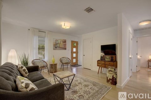 A living room with a grey couch and a coffee table.
