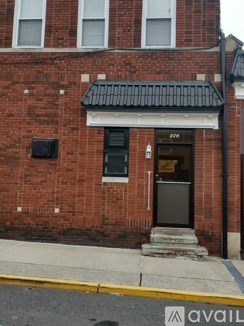 A brick building with the number 276 on the front door.