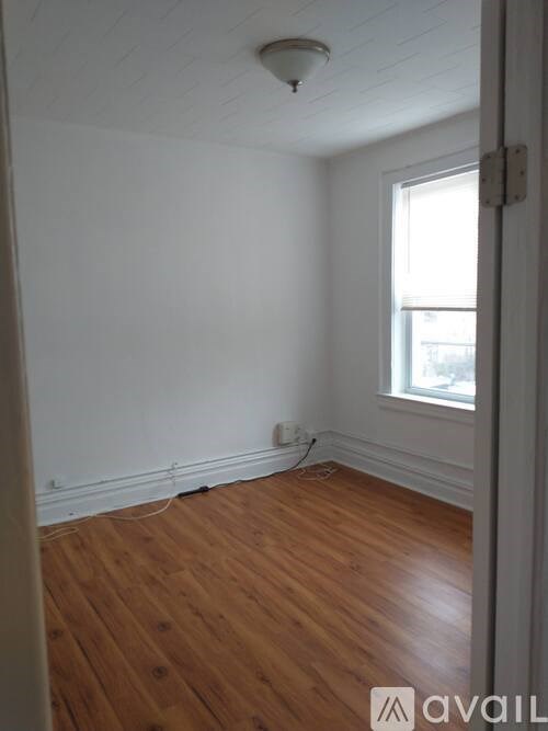 A room with wooden floors and a window.