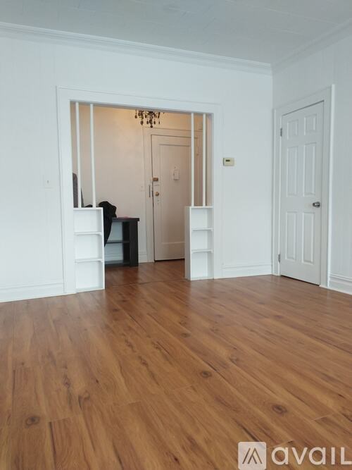 A room with wooden floors and white walls.