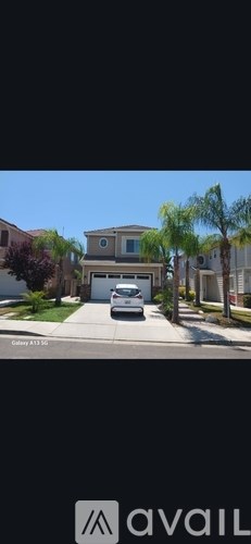 A car is parked in front of a house with the text "Galaxy A13 5G" on the image.