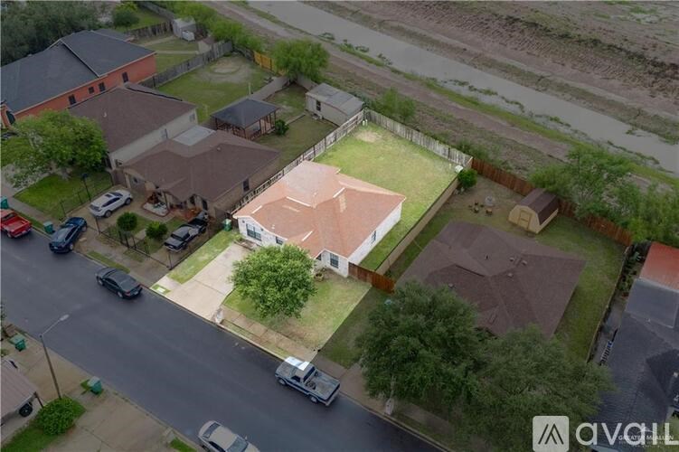 A bird's eye view of a residential area with houses and cars.