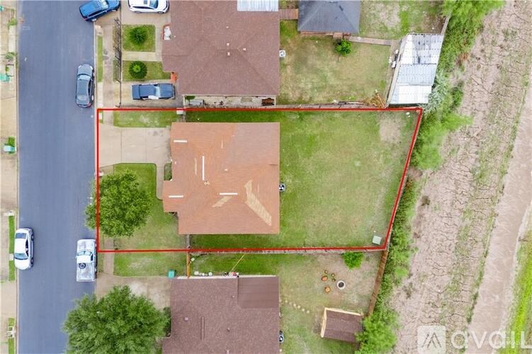 A red outlined area in the middle of a grassy yard.