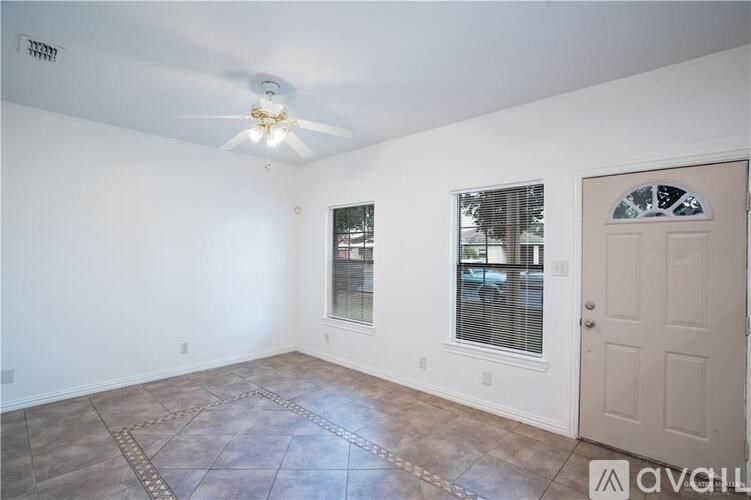 A room with a ceiling fan and a door.